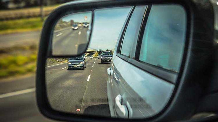 Side mirror view of cars behind you as you are merging.